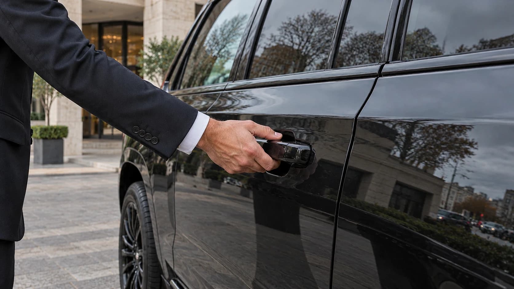 Chauffeur opening a passenger door handle